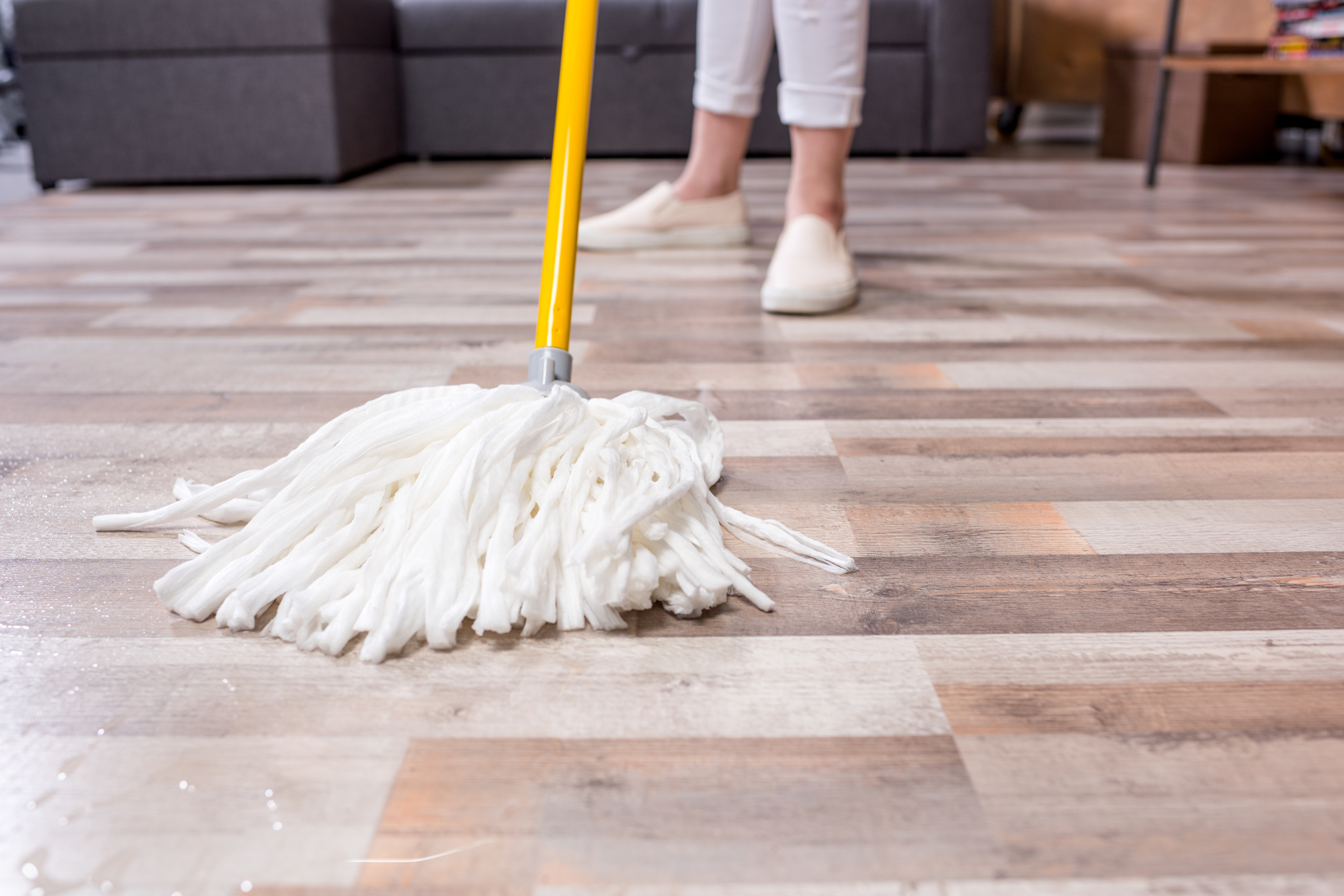 Woman cleaning floor with mop